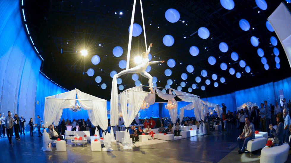 Guests at the Fire and Ice themed closing gala, lit in dramatic colour against a dark venue.