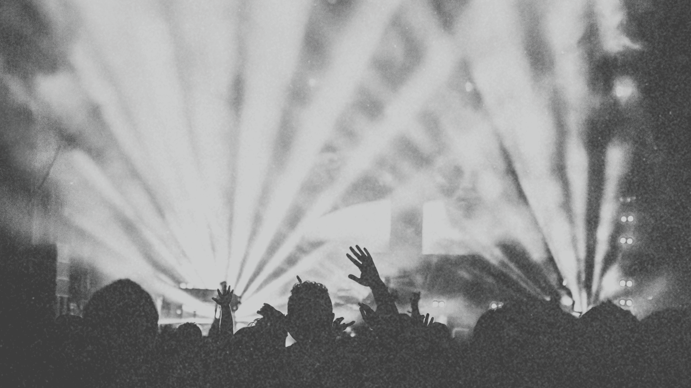 A high-energy event with vibrant lighting, a packed dance floor, and an enthusiastic crowd dancing—showcasing how to make your event stand out in 2025.